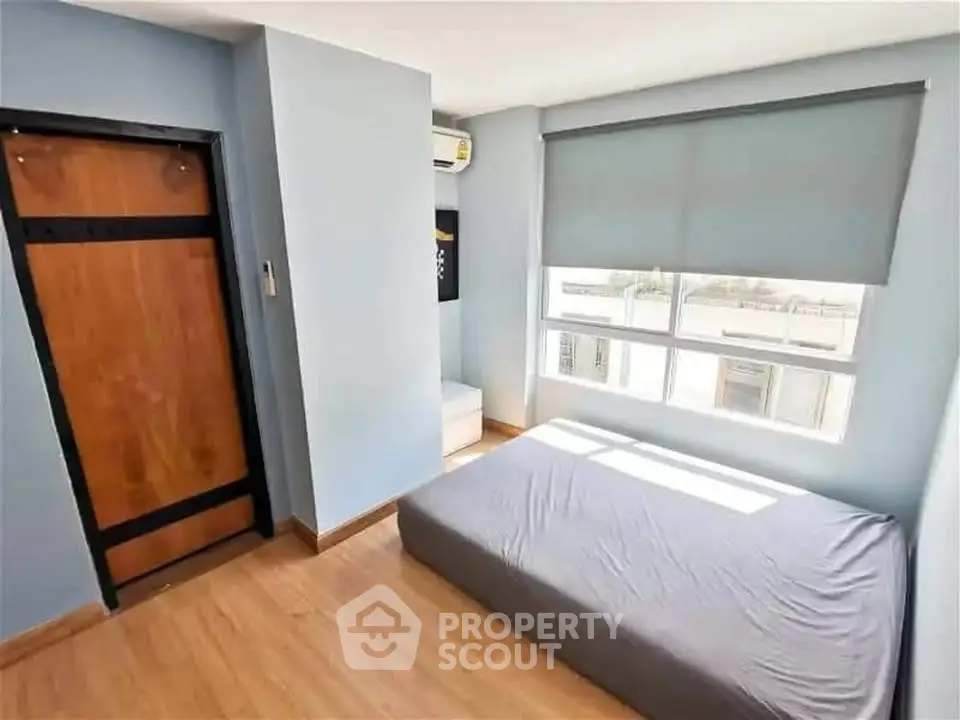 Bright and cozy bedroom with large window and modern decor