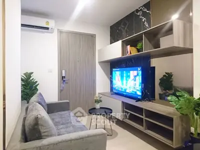 Modern living room with stylish furniture and wall-mounted TV, perfect for urban living.