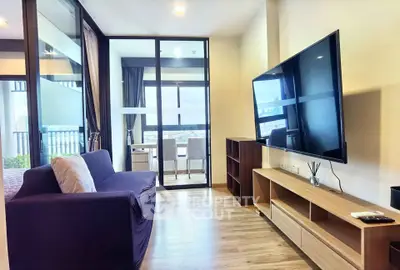 Modern living room with large TV and balcony view in stylish apartment