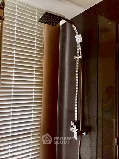 Modern bathroom with sleek shower and blinds, perfect for contemporary living.