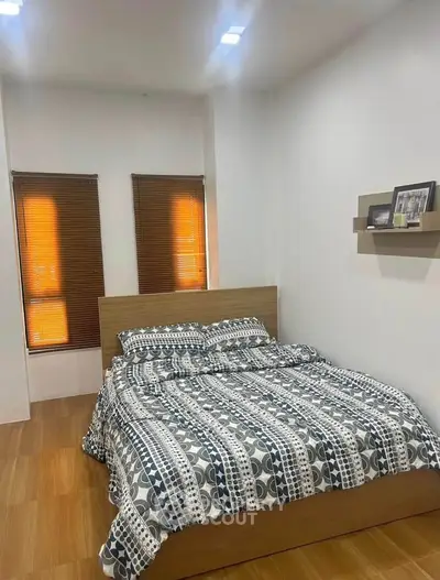 Cozy bedroom with modern decor and wooden flooring, perfect for relaxation.
