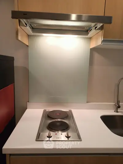 Modern kitchen with electric stove and sleek cabinetry