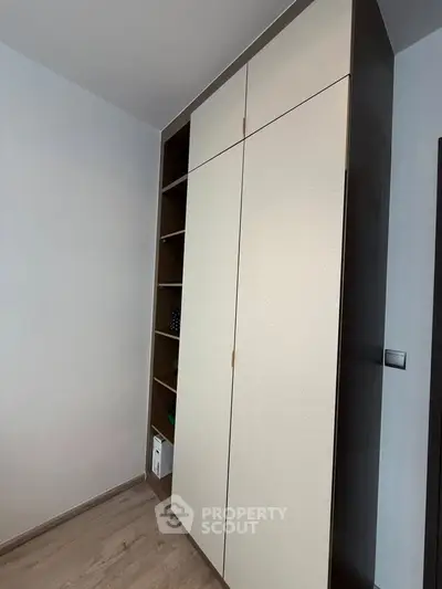 Modern built-in wardrobe with sleek design and ample storage space in a contemporary home interior.