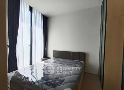 Modern bedroom with large windows and stylish decor