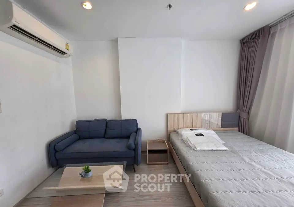 Modern studio apartment with cozy sofa and comfortable bed