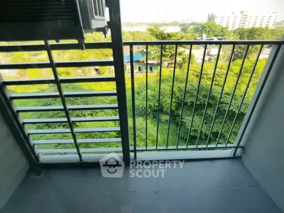Charming balcony with lush green view, perfect for relaxation and enjoying nature.