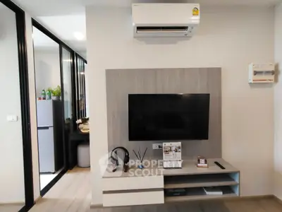 Modern living room with sleek TV setup and air conditioning