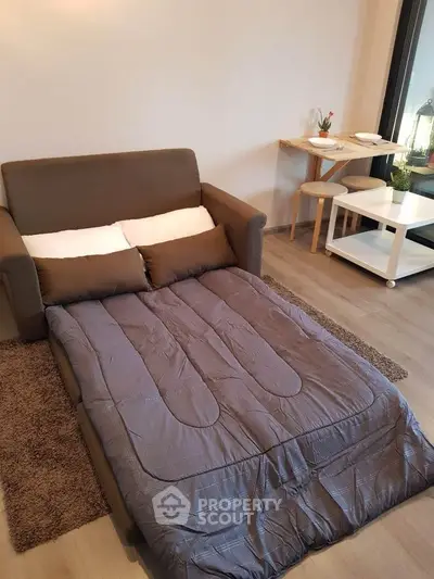 Cozy living room with sofa bed and dining area in modern apartment