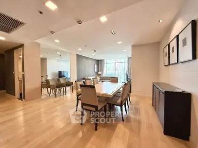 Spacious modern dining and living area with elegant decor and natural light.