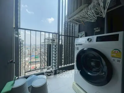 High-rise apartment balcony with city view and modern washing machine.