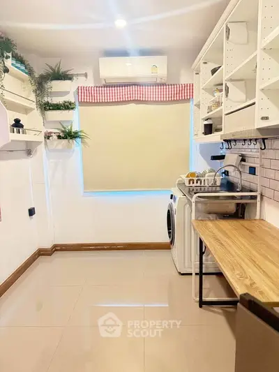 Charming kitchen with modern appliances and stylish open shelving, perfect for culinary enthusiasts.