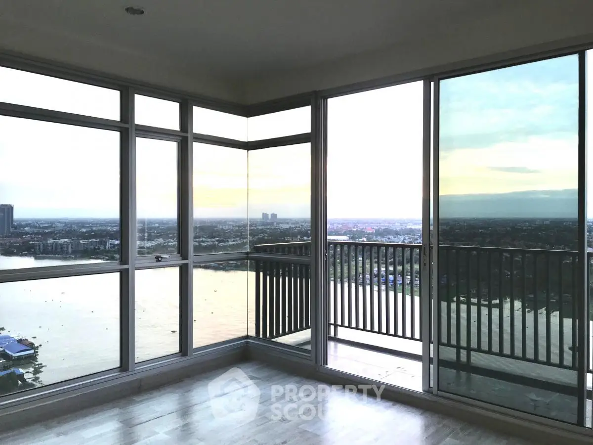 Stunning corner unit with panoramic city and water views from floor-to-ceiling windows.