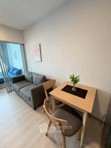 Cozy living room with modern furniture and natural light, perfect for relaxation.