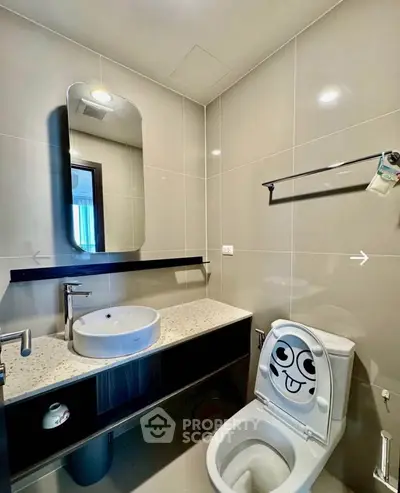 Modern bathroom with stylish fixtures and unique toilet design in a contemporary apartment.