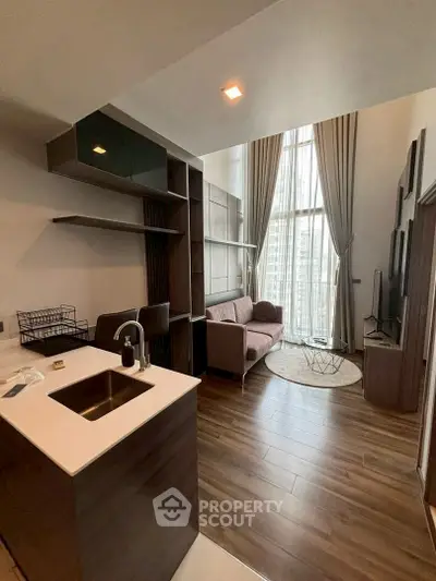 Modern loft apartment with high ceilings, large windows, and stylish interior design.
