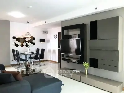 Modern living room with sleek furniture and dining area, featuring contemporary design and stylish decor.
