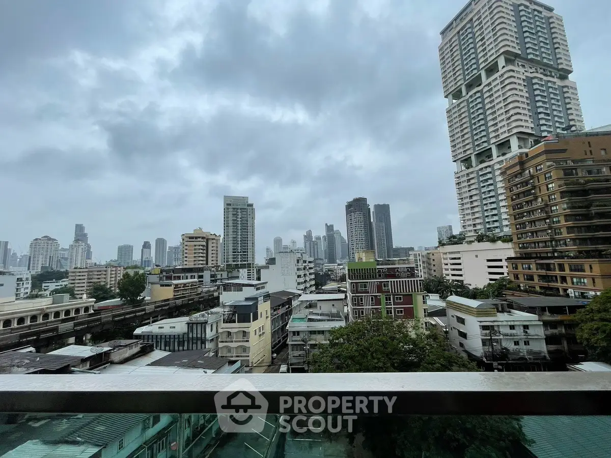 Stunning cityscape view from a high-rise balcony showcasing urban skyline and modern architecture.