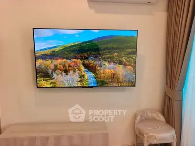 Modern living room with wall-mounted TV and scenic view, elegant curtains, and stylish furniture.