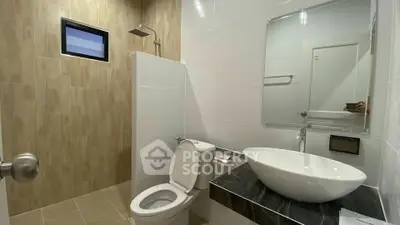 Modern bathroom with sleek fixtures and stylish tile design.