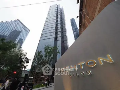Stunning modern high-rise building in Silom with sleek glass facade and urban surroundings.