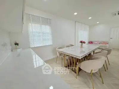 Elegant dining area with marble table and plush chairs in modern home