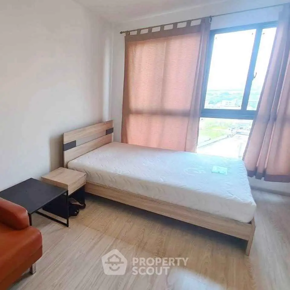 Cozy bedroom with natural light and modern furnishings, perfect for a serene living experience.