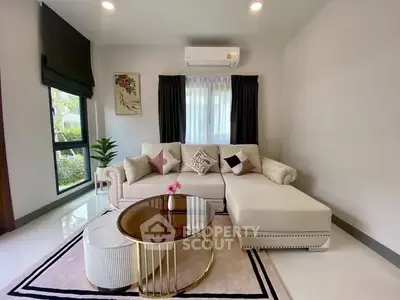 Elegant living room with stylish sofa, chic coffee table, and modern decor in a bright, inviting space.