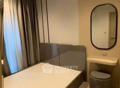 Modern bedroom with sleek design and stylish furnishings in a contemporary apartment.