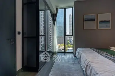 Modern bedroom with city view and large windows in high-rise apartment