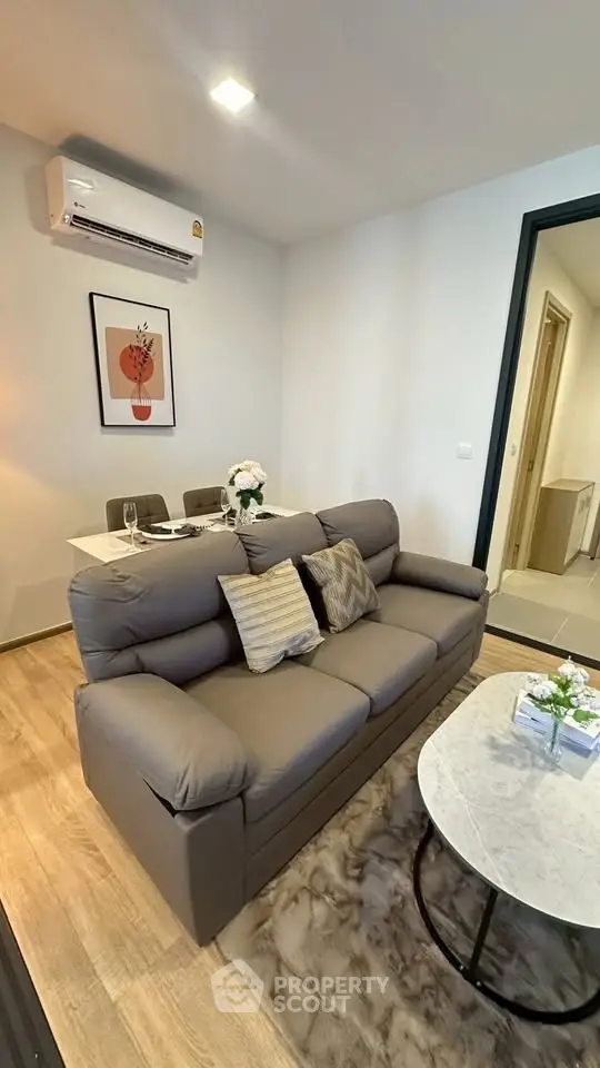 Modern living room with cozy sofa and dining area in stylish apartment