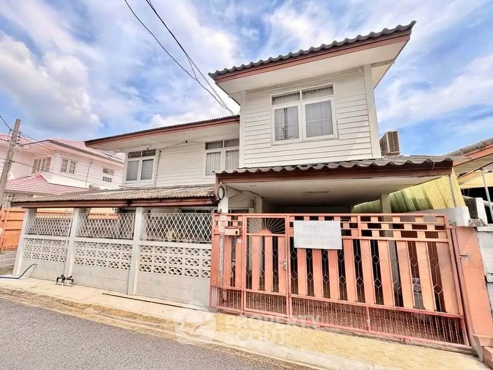 Charming two-story house with gated entrance and traditional design in a quiet neighborhood.