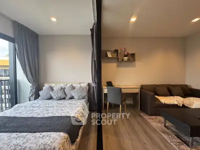 Modern studio apartment with cozy bedroom and stylish living area, perfect for urban living.