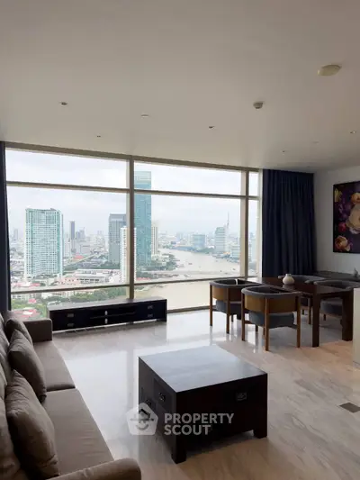 Stunning living room with panoramic city view, modern furniture, and floor-to-ceiling windows.