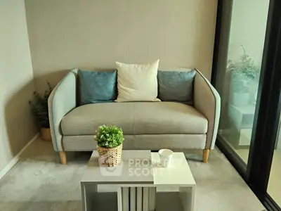 Cozy living room with modern sofa and coffee table, perfect for relaxation.