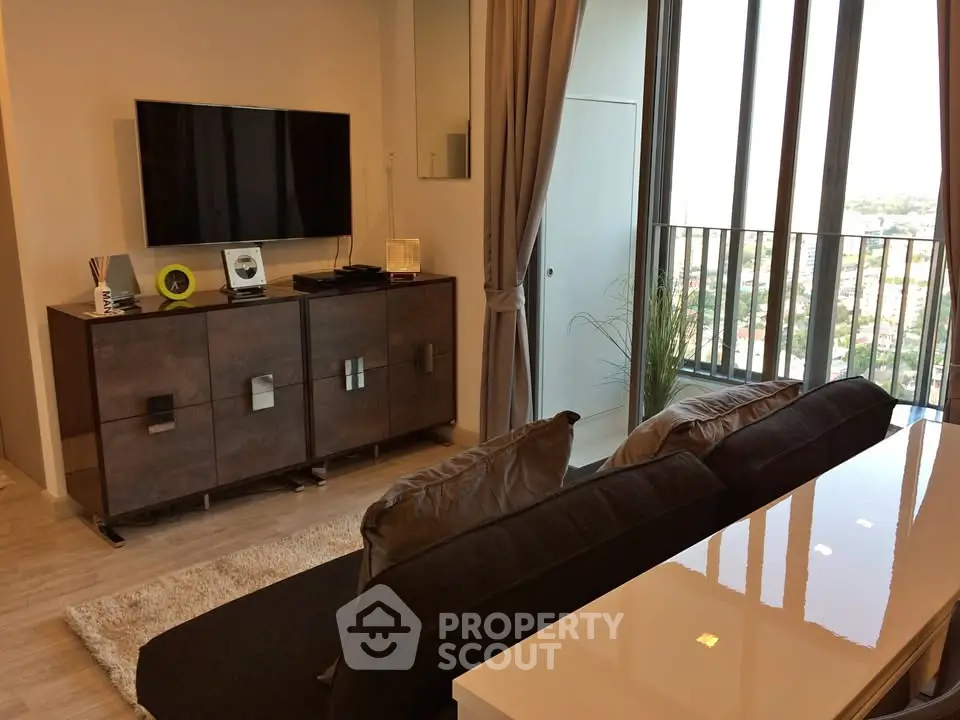 Modern living room with sleek furniture and large windows offering a stunning view.