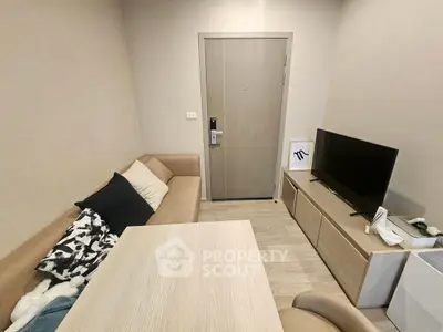 Cozy living room with modern furniture and TV setup, perfect for relaxation.