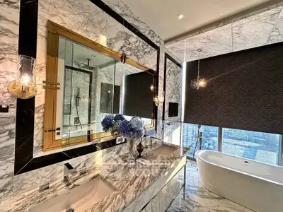 Luxurious marble bathroom with city view and freestanding bathtub