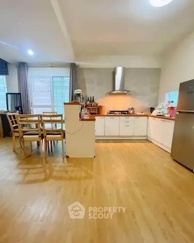Spacious kitchen with dining area and modern appliances in open layout