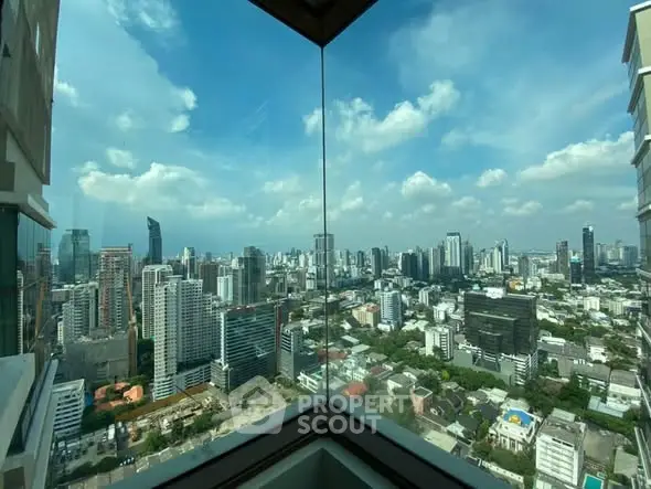 Stunning cityscape view from a high-rise corner unit with expansive windows.