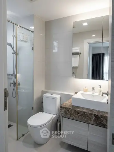 Modern bathroom with sleek fixtures and glass shower enclosure