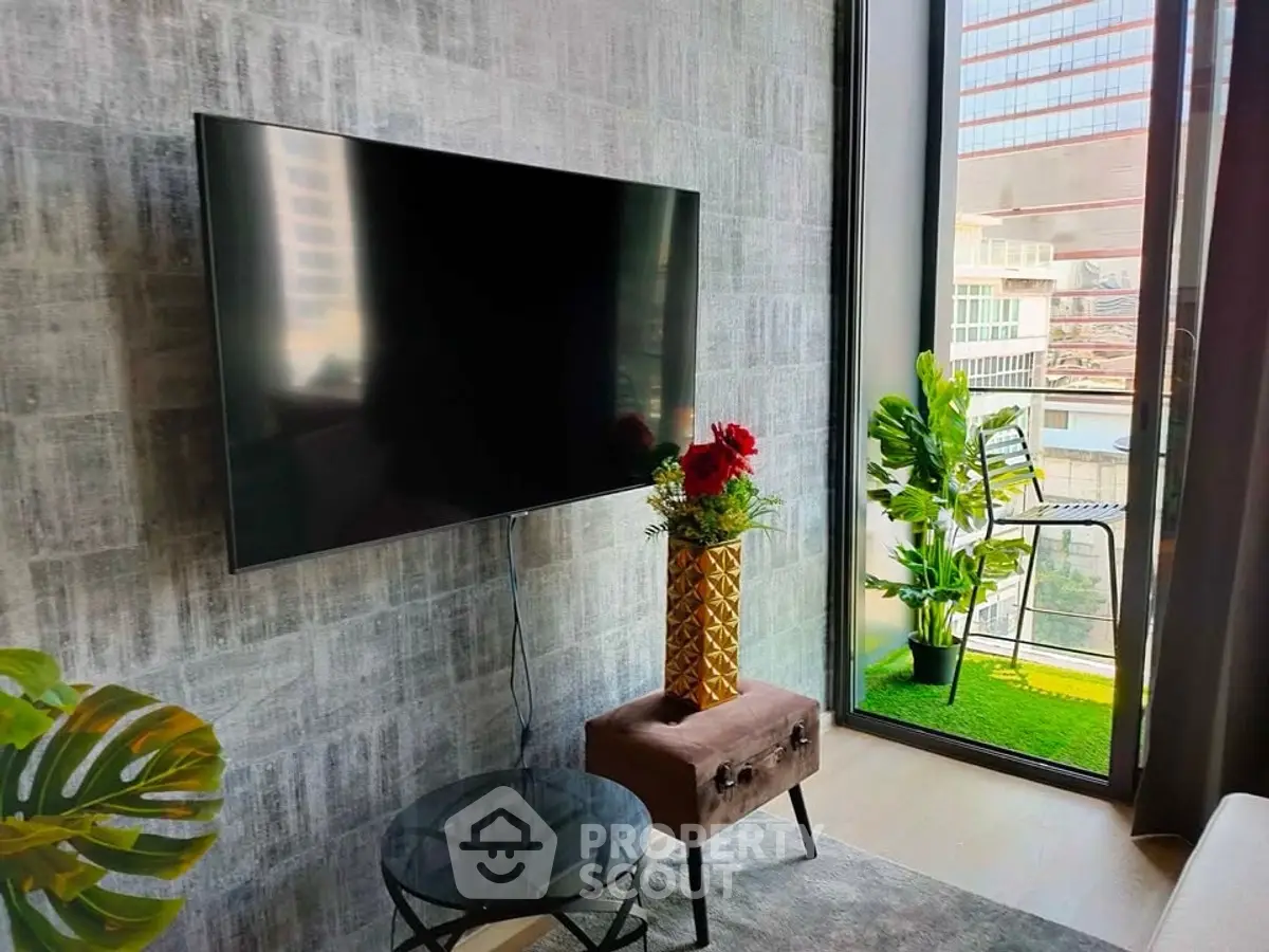 Modern living room with large TV and city view