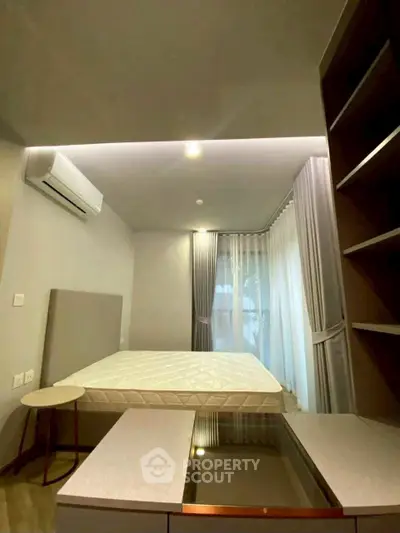 Modern bedroom with air conditioning and stylish furnishings
