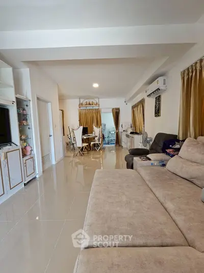 Spacious living room with modern decor and elegant dining area