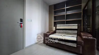 Cozy living room with modern sofa and built-in shelving, perfect for relaxation and storage.