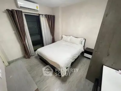 Cozy bedroom with modern furnishings and air conditioning, featuring a comfortable bed and stylish curtains.