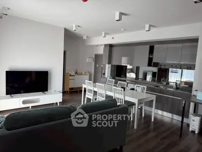 Modern open-plan living room with sleek kitchen and dining area