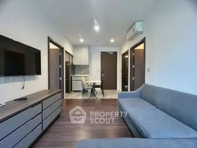 Modern living room with sleek furniture and open kitchen layout