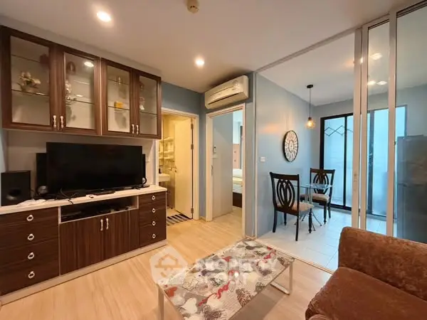 Cozy living room with modern decor and open dining area, perfect for urban living.