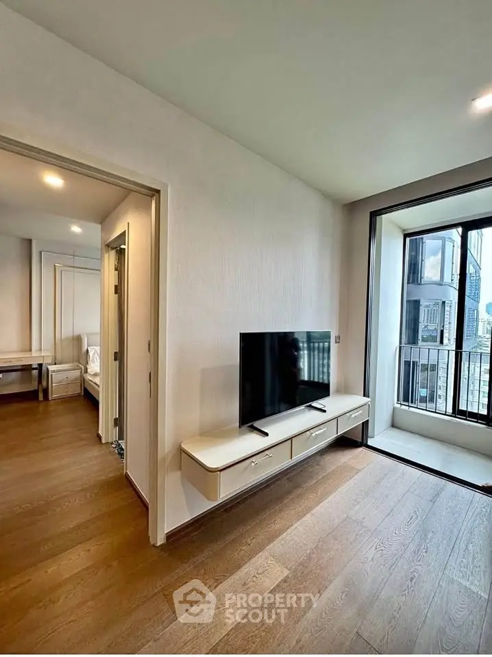 Modern living room with TV and balcony view in a stylish apartment
