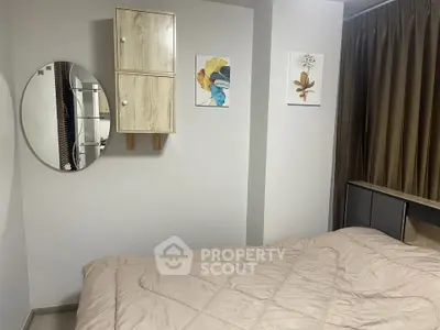 Cozy bedroom with modern decor and stylish wall art, perfect for relaxation.